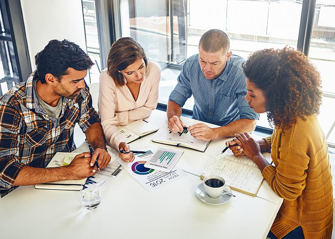 A team of designers engaged in a meeting in an office.