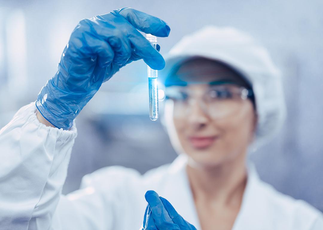 A female scientist checking water quality from a sample.