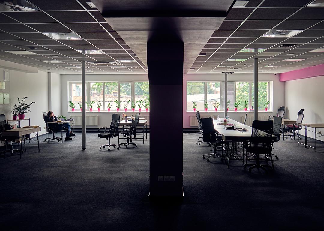 A female employee alone in a big office.