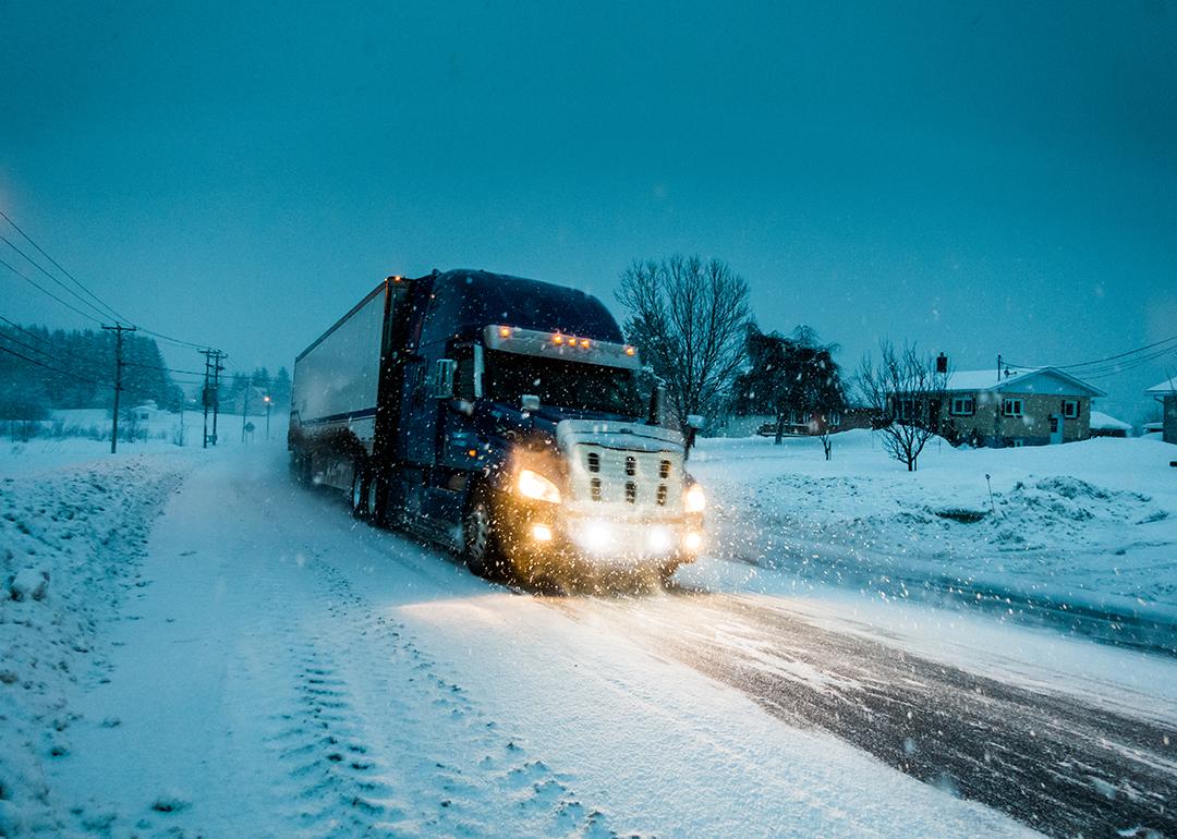 A truck passing on a road during a blizzard in Gaspe, Quebec, Canada.