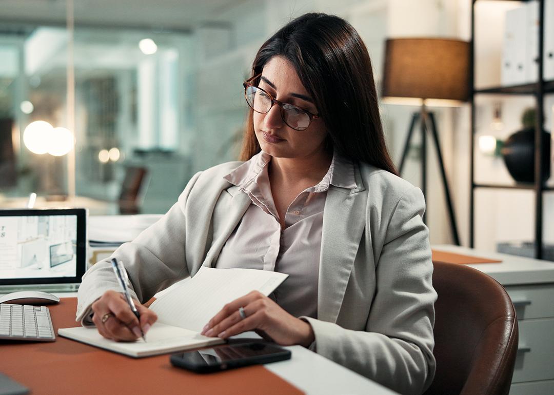 An employee planning schedules with a calendar for corporate activities at work.