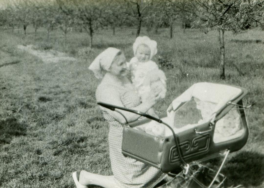 A vintage photo of a grandmother with her grandchild outdoors.