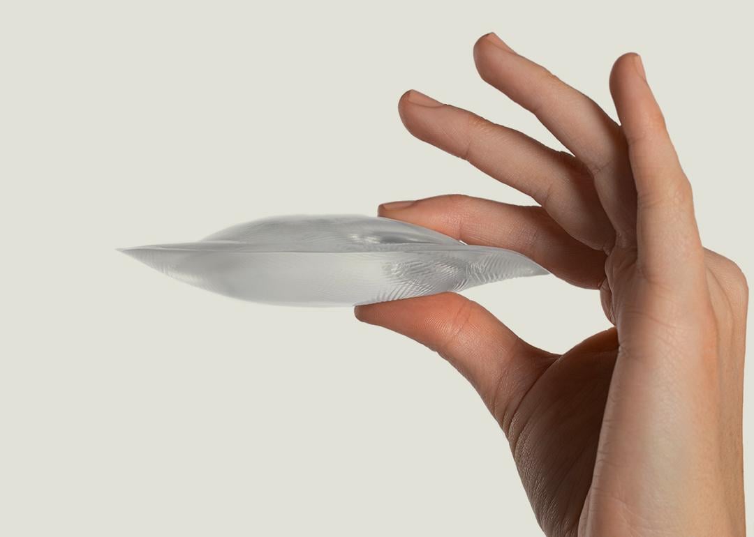 Person holding a pair of silicon gel bra inserts.