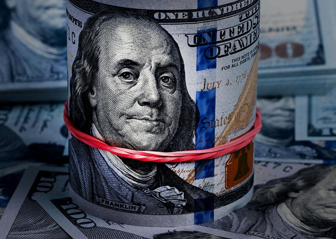 Close up on a rolled band of US dollar banknotes.