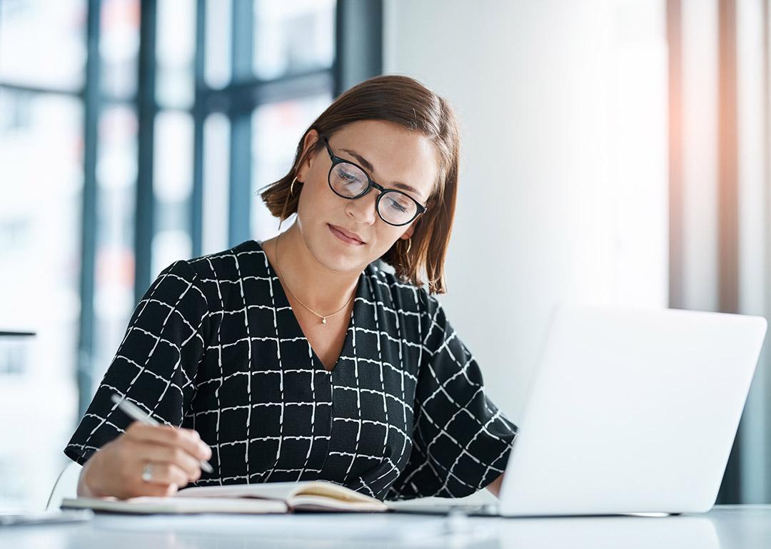 An office employee drafting a proposal for a stakeholder organization.