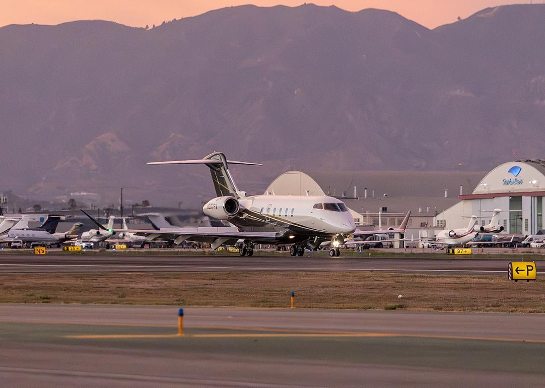 A Bombardier Challenger 3500 aircraft landing on runway in Van Nuys Airport in California.