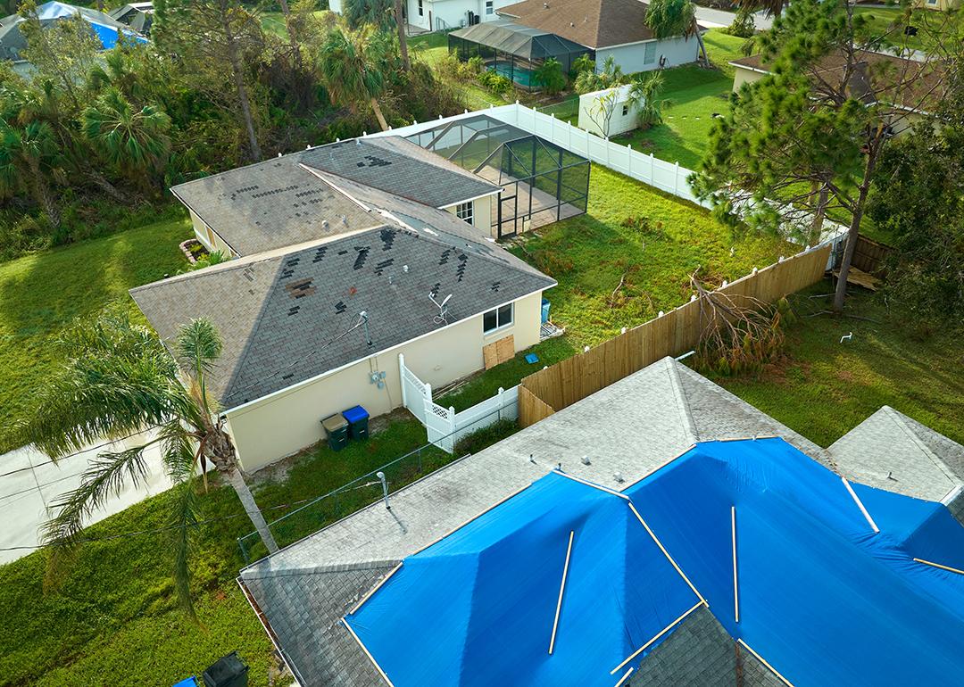 Aerial view of a house's roof damaged by Hurricane Ian in Florida.