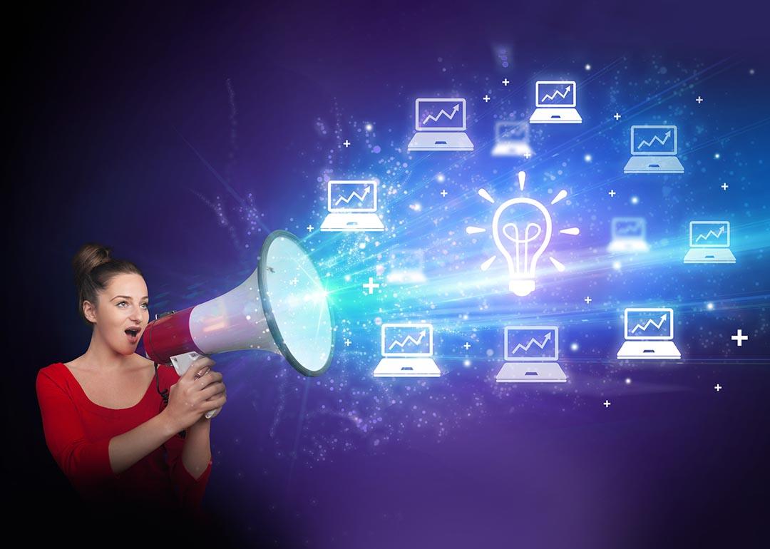 A young woman with a megaphone illustrated with shouting out business email graphics as a concept of marketing.
