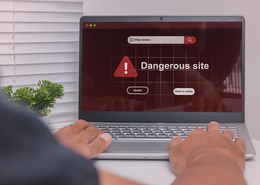A dangerous site warning displayed on a laptop.