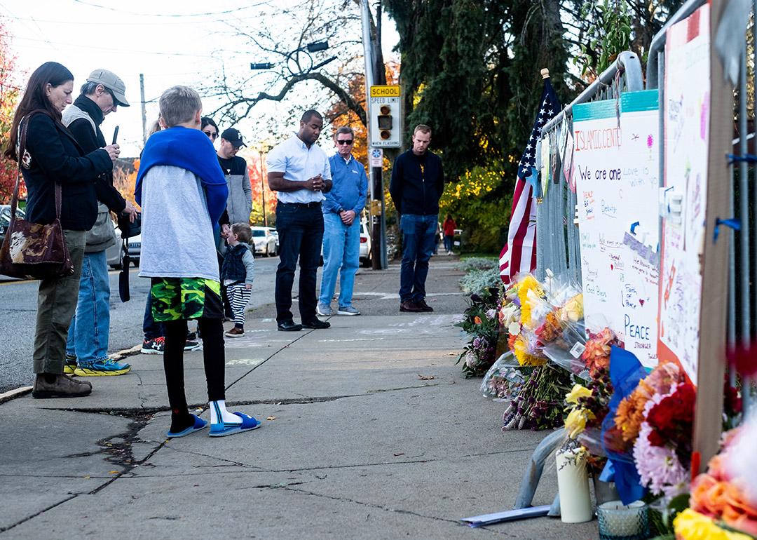 People gathering and paying their respects at a memorial, one year after the shooting at the Tree of Life synagogue in Squirrel Hill, Pittsburgh, USA.