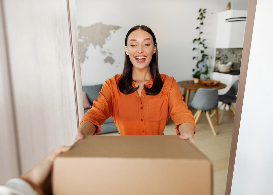 A happy woman receiving a package.