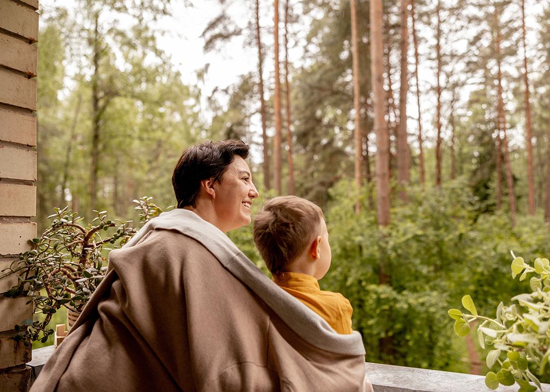 A grandmother enjoying outdoor view with her young grandson.