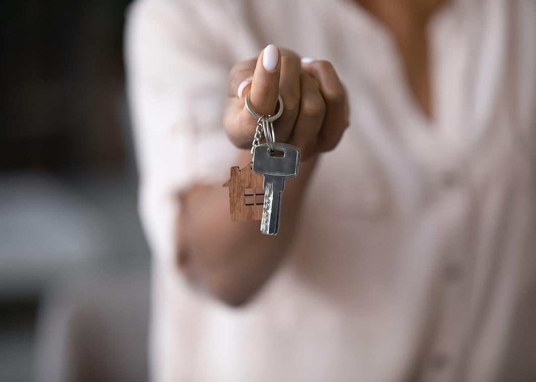 A man holding keys to a new home.