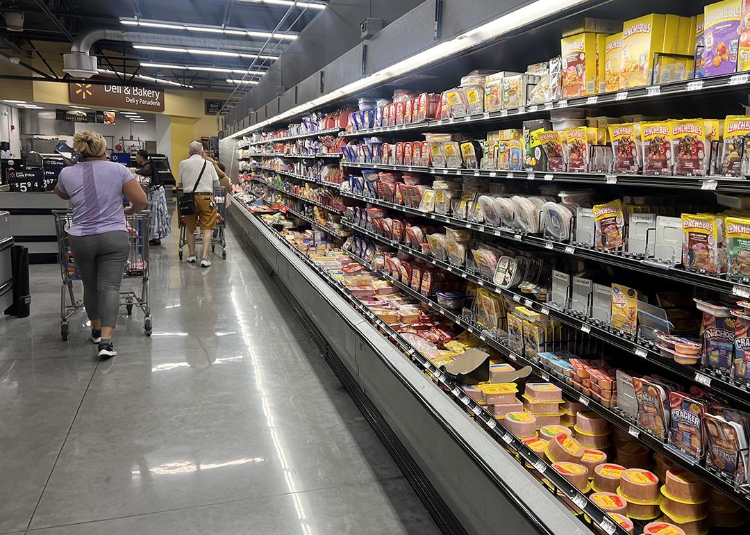 Customers shop in the deli meat aisle of a grocery store in Miami, Florida.