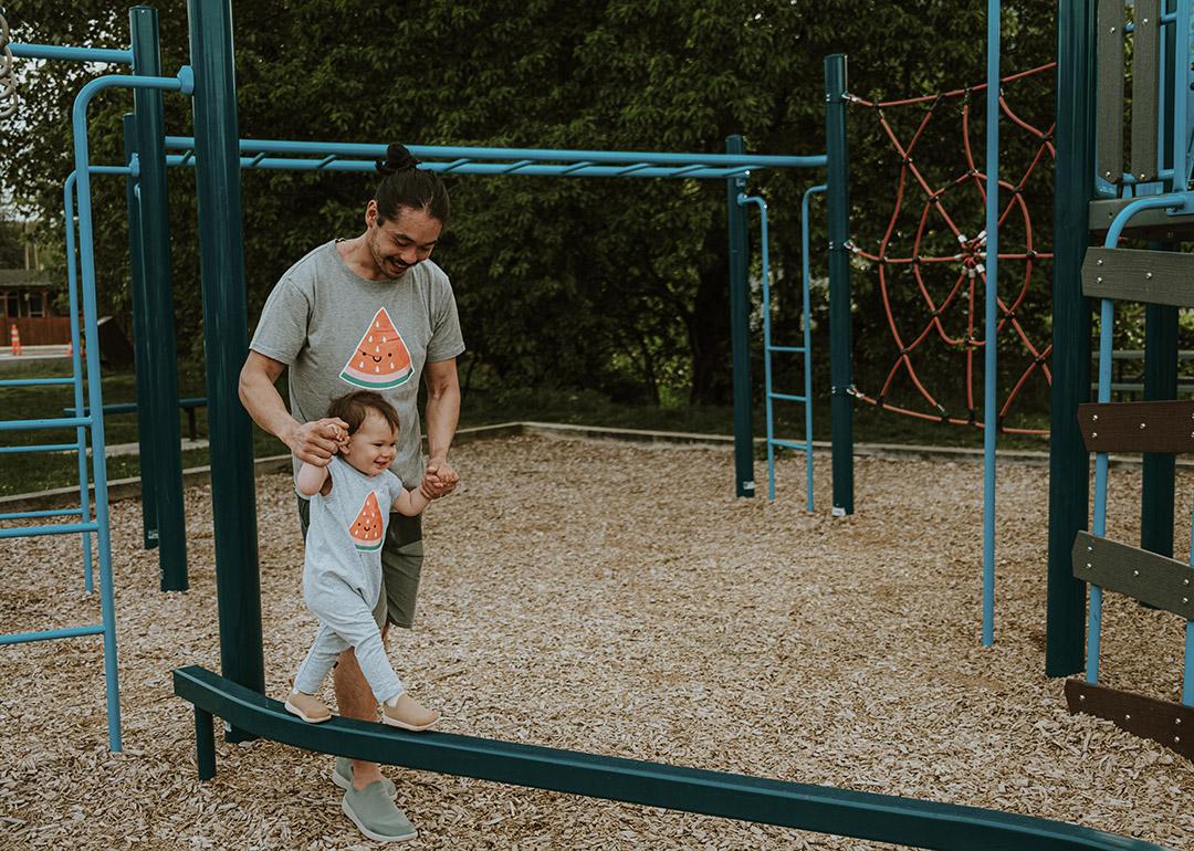 A father and his son bonding together in a playground.