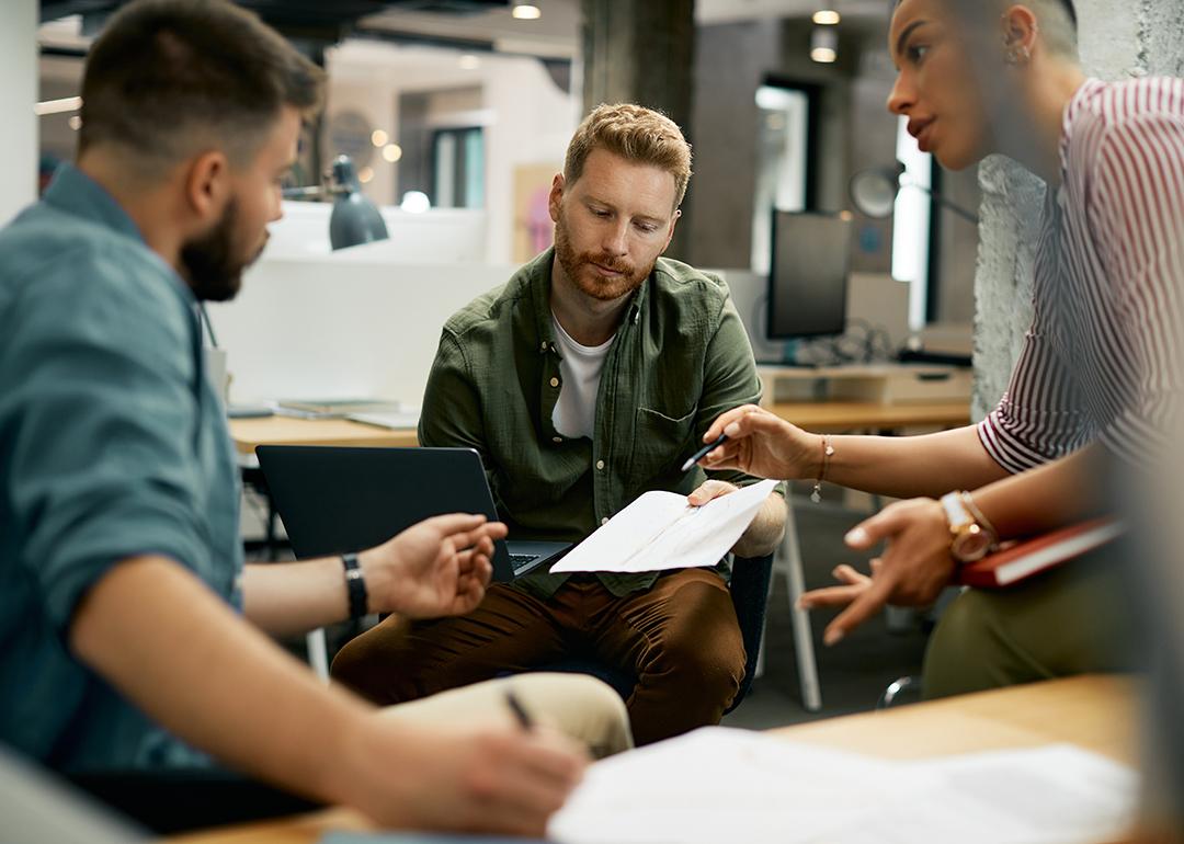 Freelance workers discussing a report.