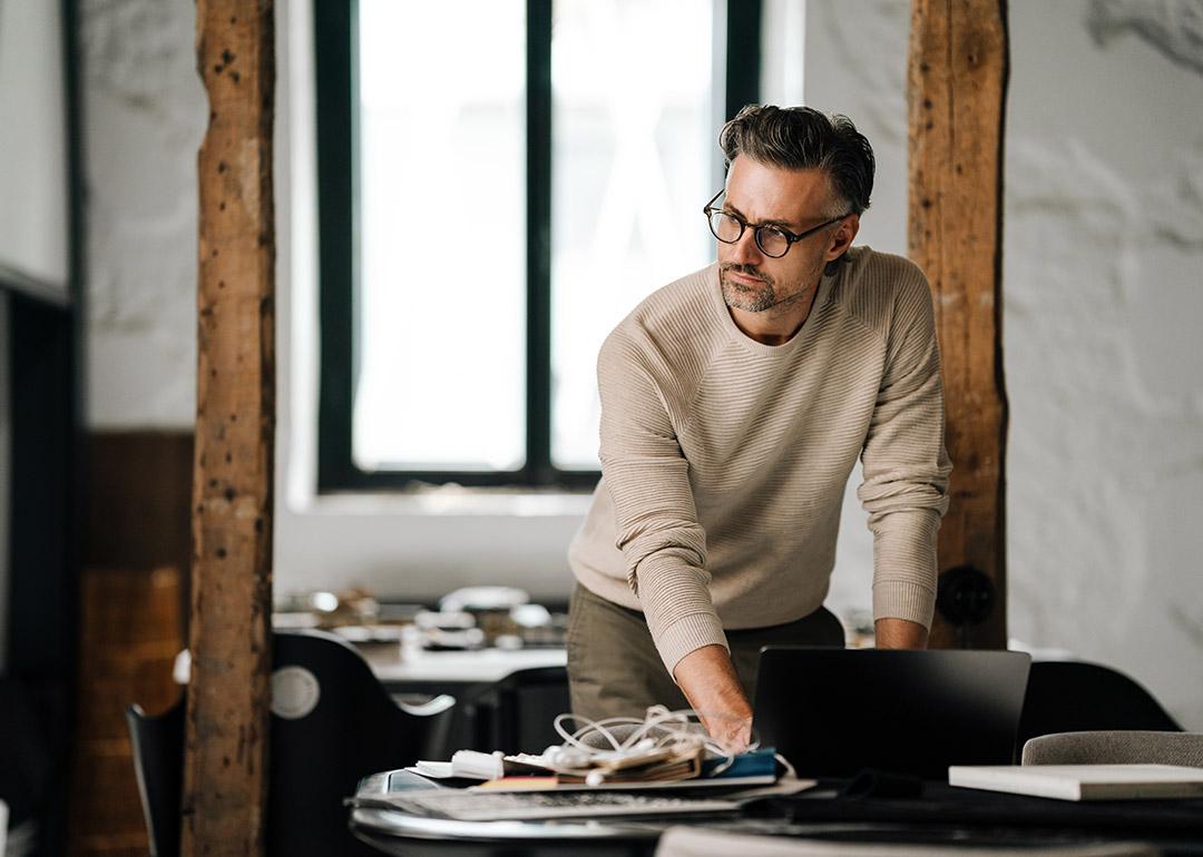 A businessman working from his laptop in an office.