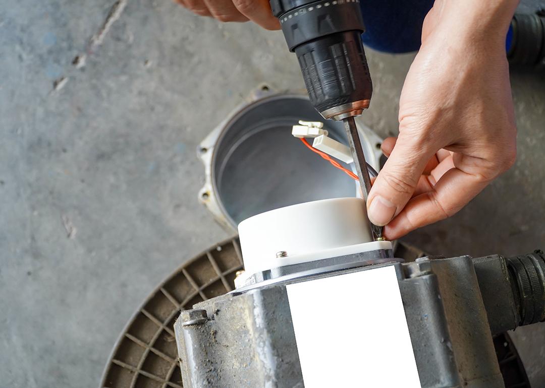 A repairman removing servo electric motor in a workshop.