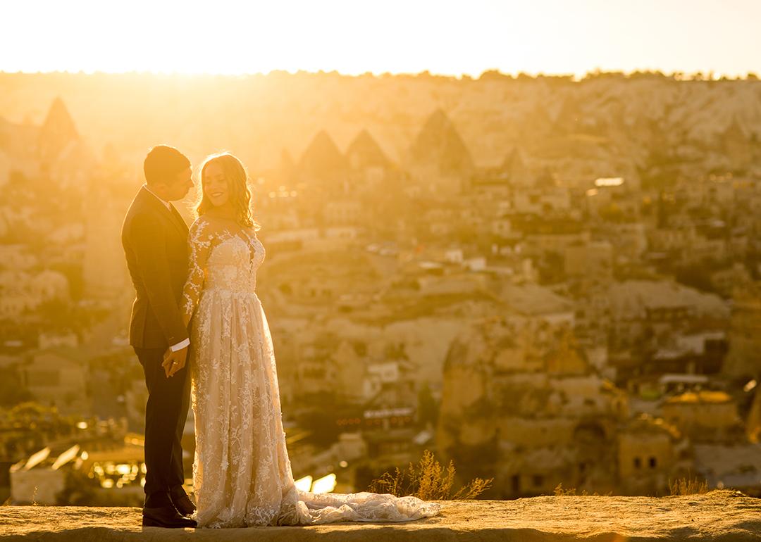 A couple poses for a sunset wedding photograph in their venue in Cappadocia, Turkey.