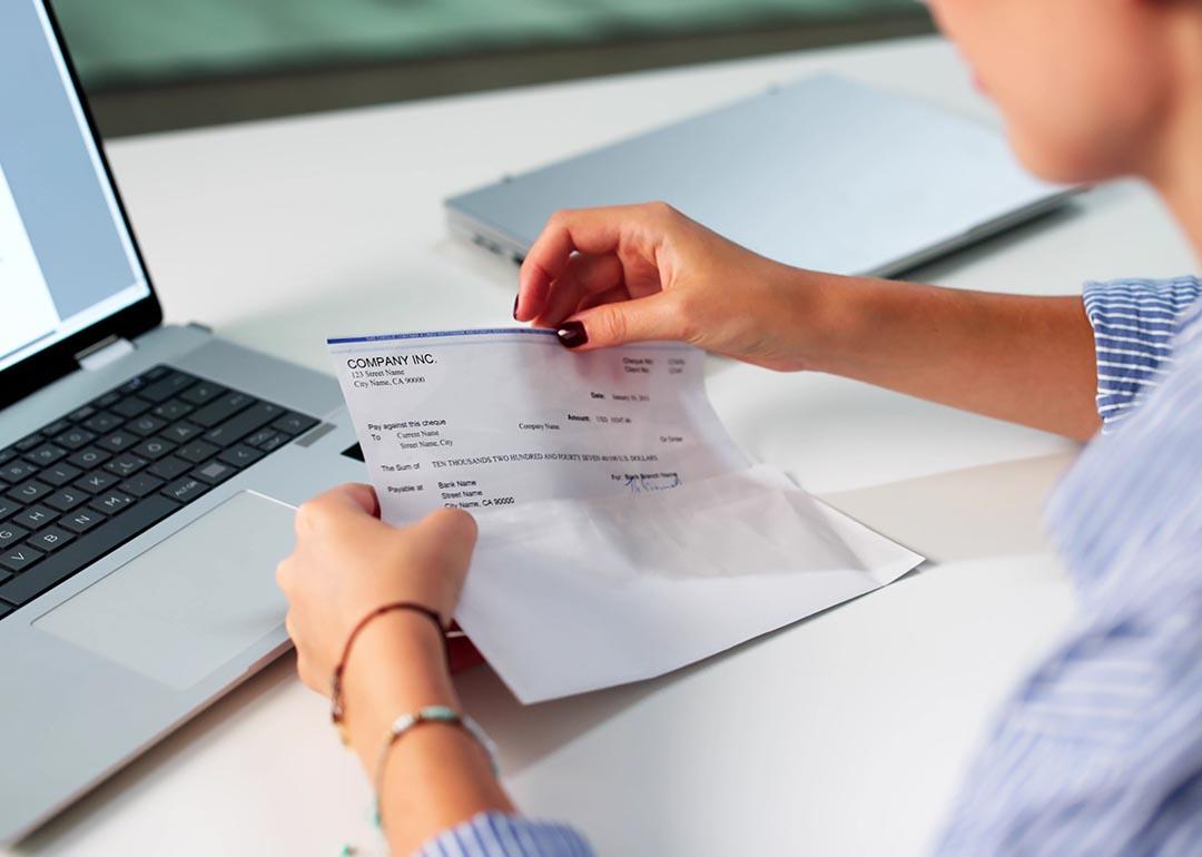 A payroll officer reviewing a compensation check.