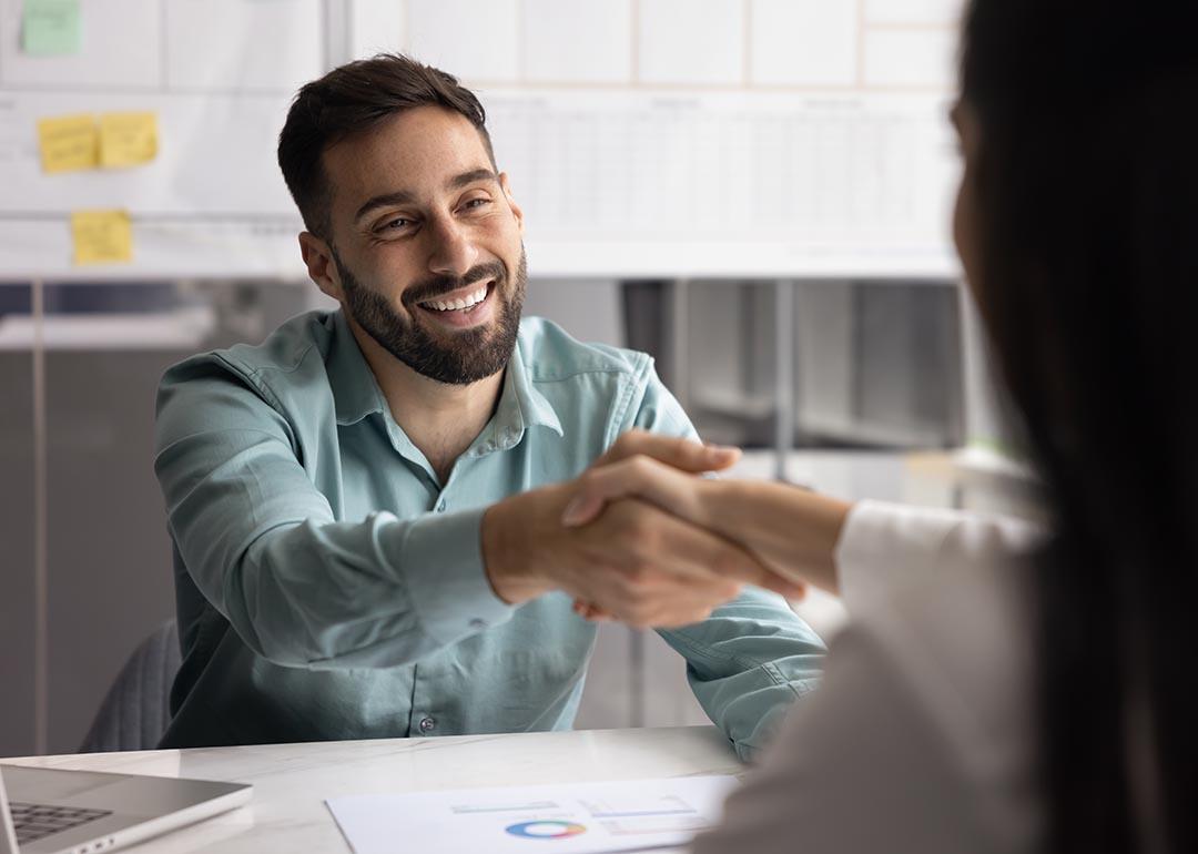 Business partners shaking hands after closing a business account deal.