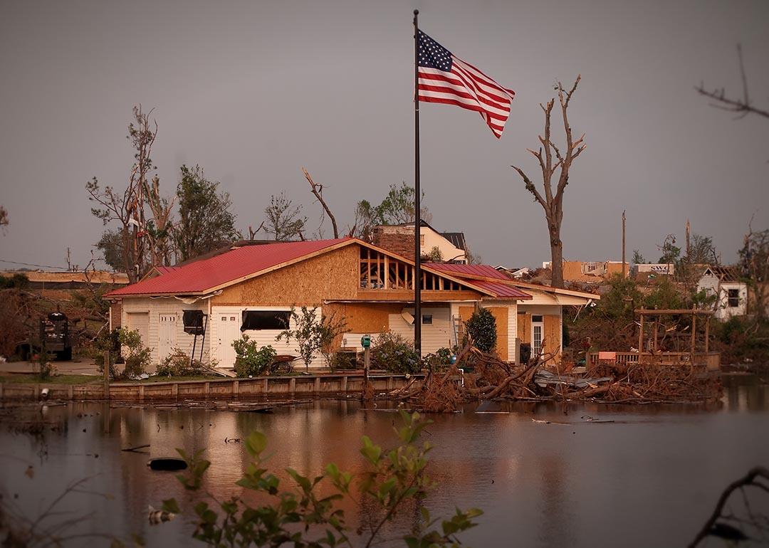 A new American flag pole standing outside a damaged Forest Lake house after the 2011's EF4 tornado in Tuscaloosa, Alabama.