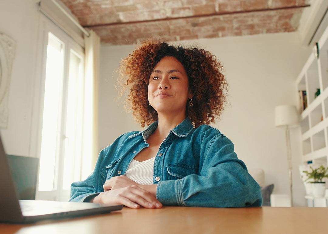 A young adult working remotely from her cozy home workspace.