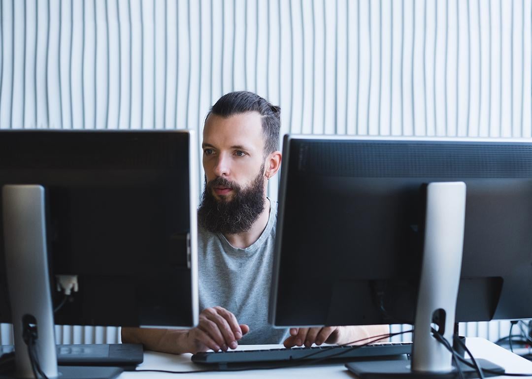 A software engineer working on a quality assurance task in an office.