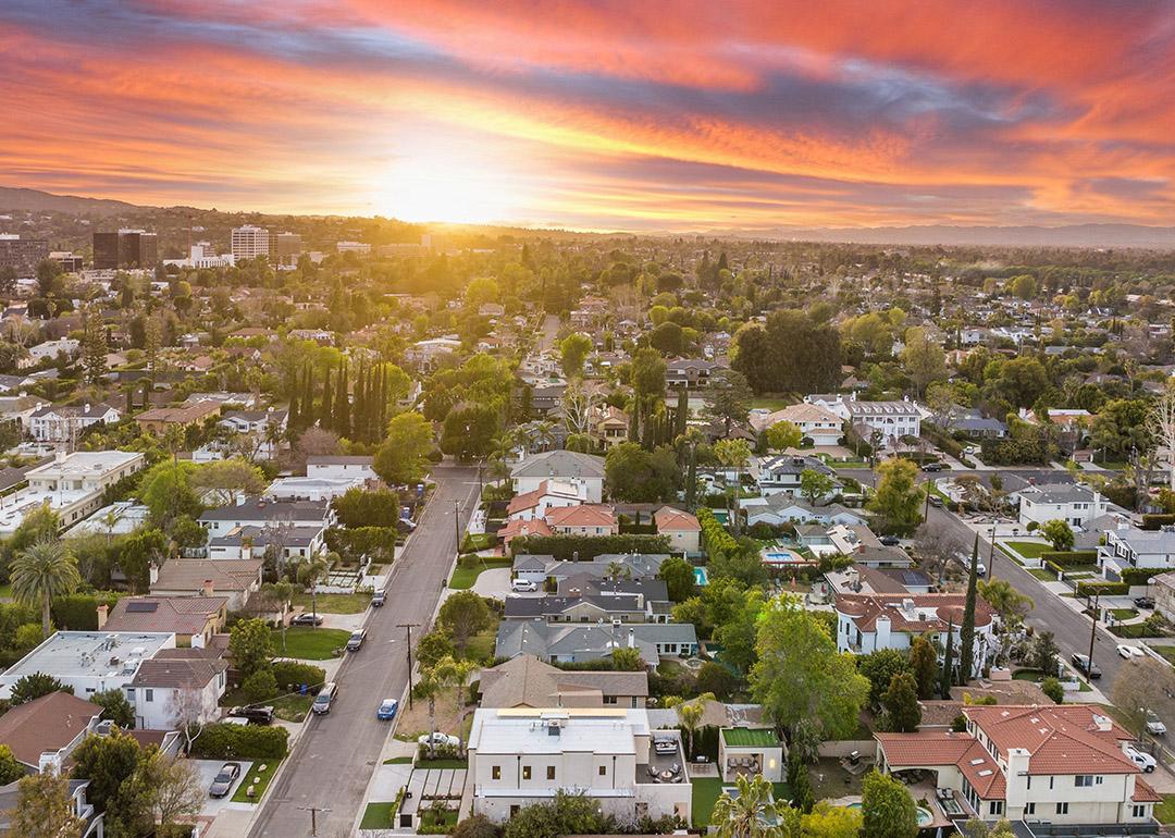 Aerial view of a suburban neighborhood at sunset.