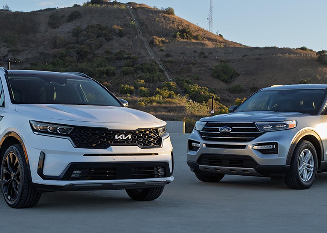 Ford Explorer and Kia Sorento cars parked outdoors.