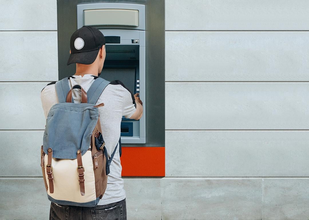 A tourist withdraws from an ATM.