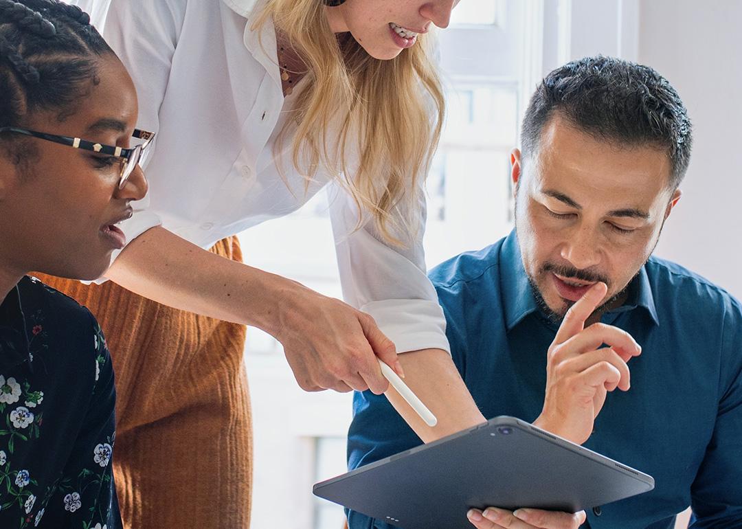 A team of colleagues collaborating for a work project in an office.