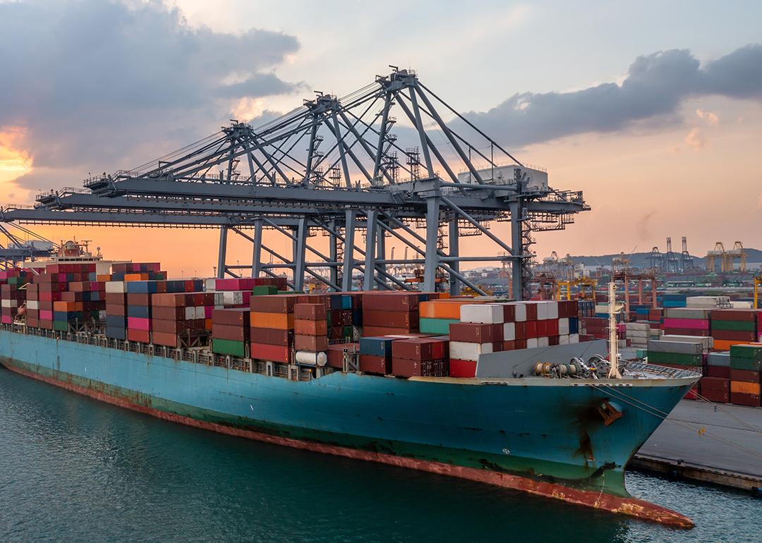 A commercial cargo ship at a terminal seaport.