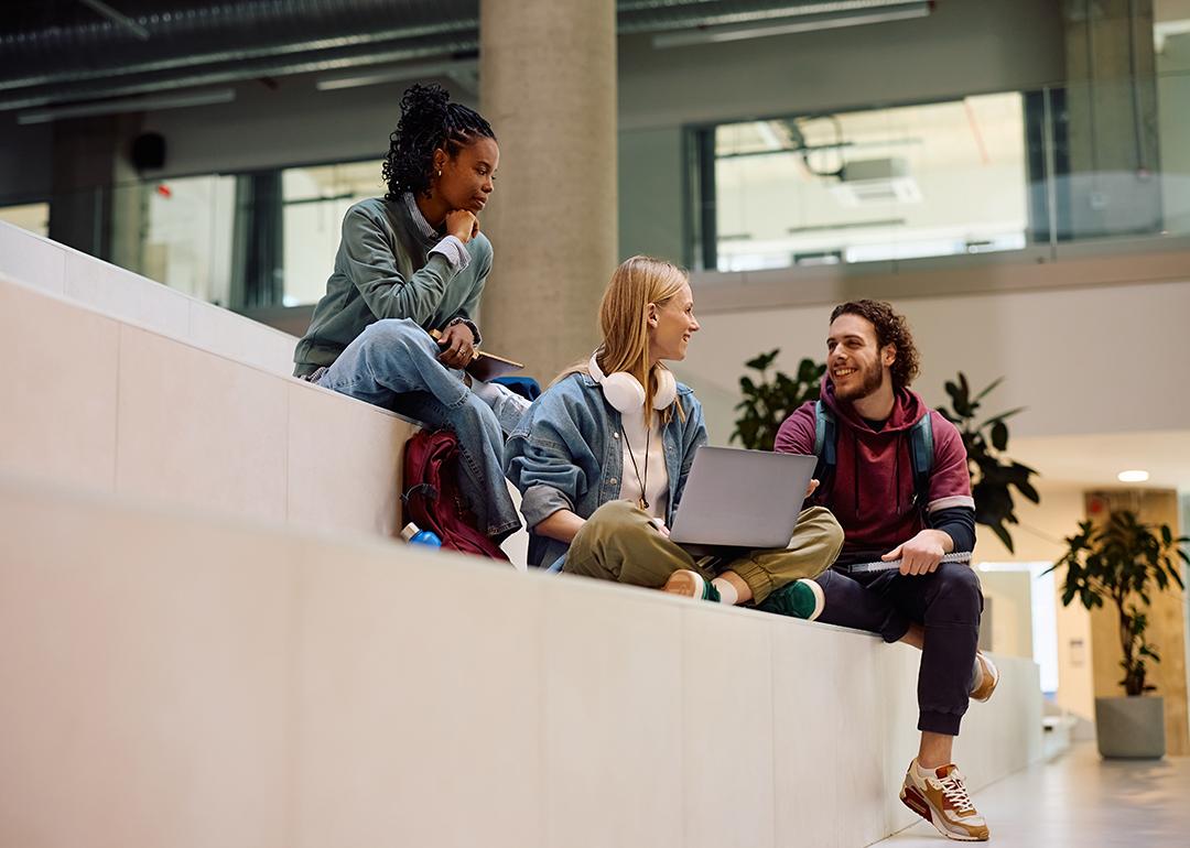 A diverse group of university students having a discussion in campus.