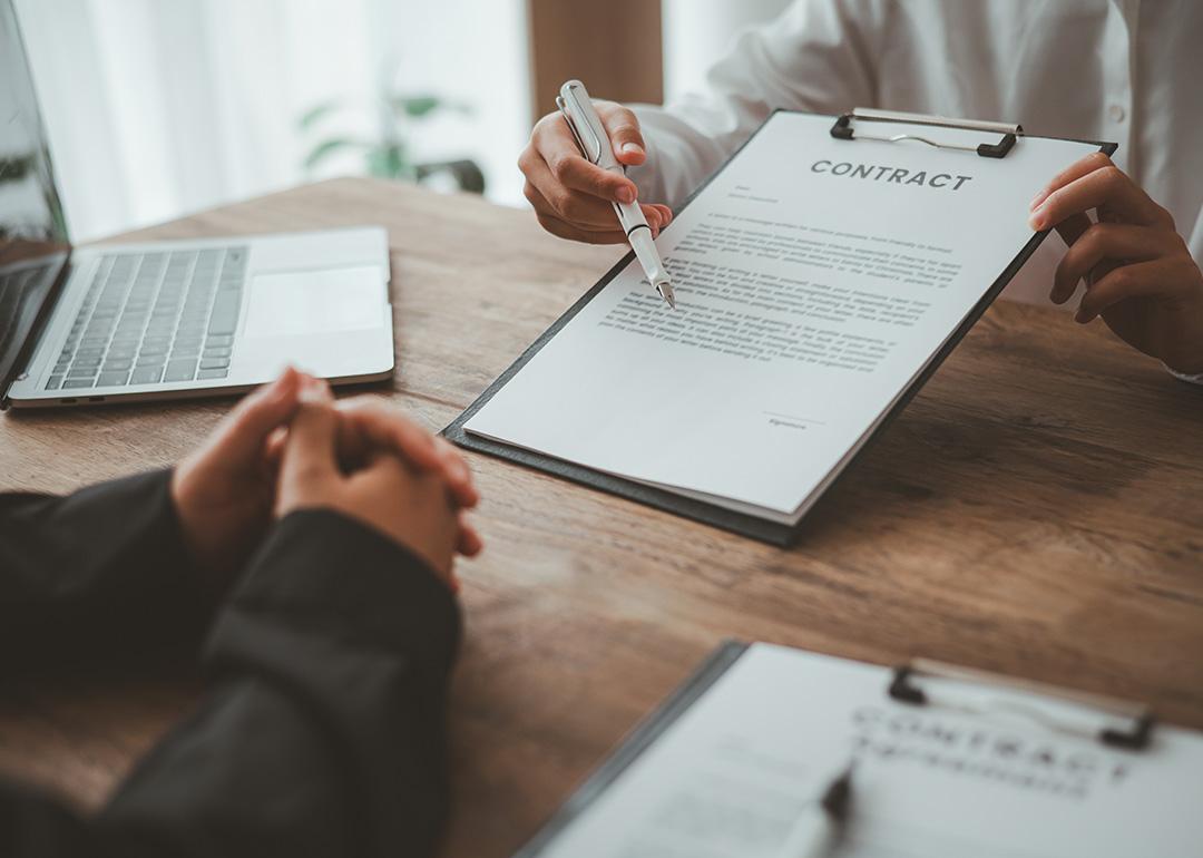 A business partner explaining agreements and matters from a contract to her co-partner.