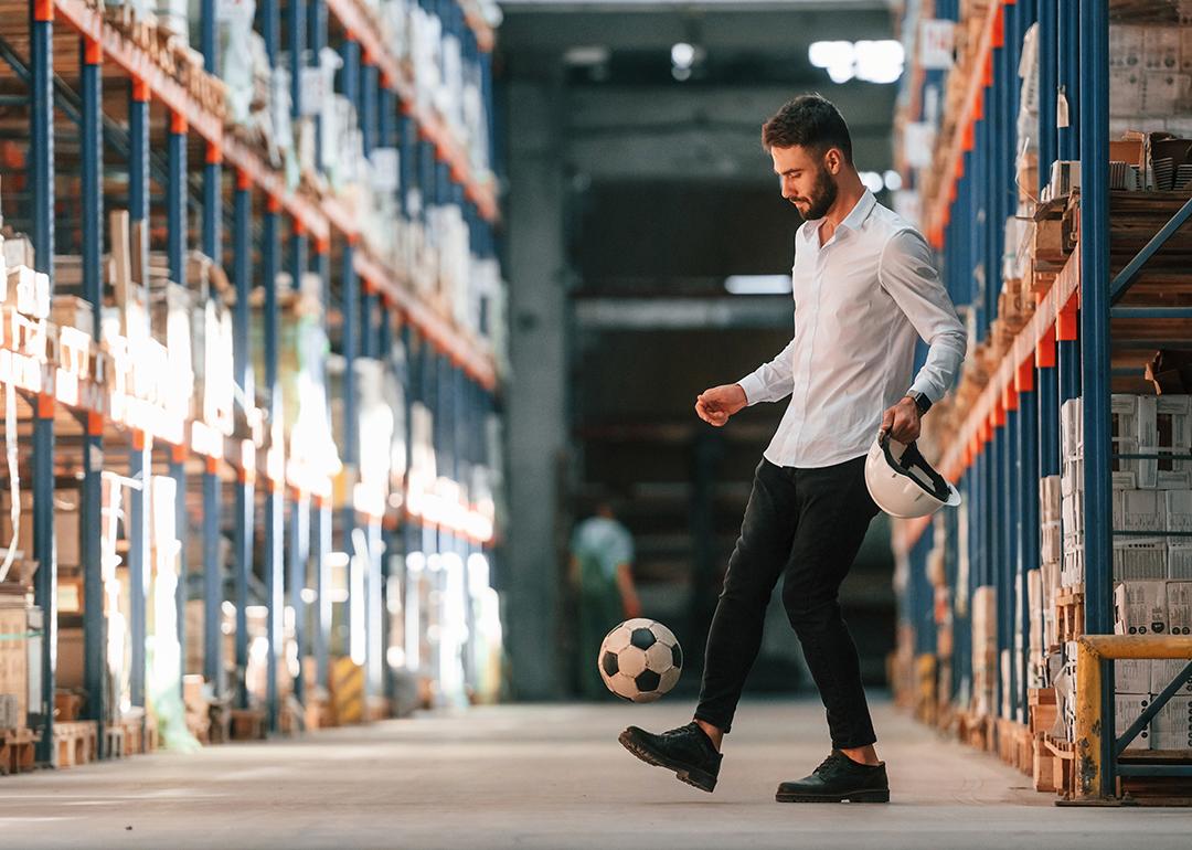 A storage working kicking a soccer ball.