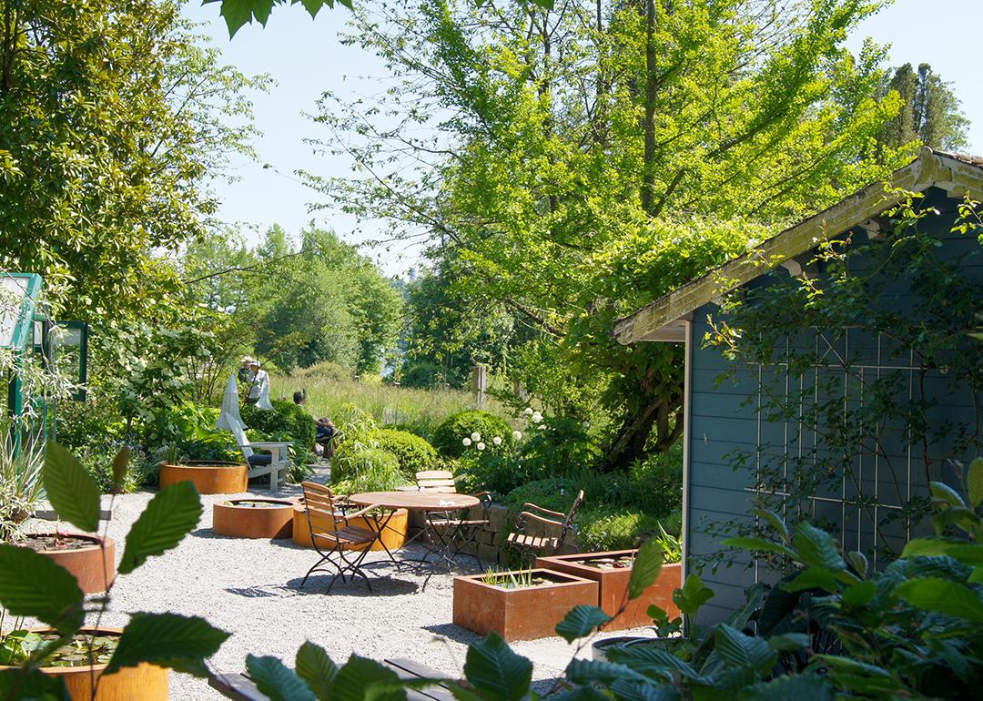 A lovely garden space with outdoor seating area and a garden shed.