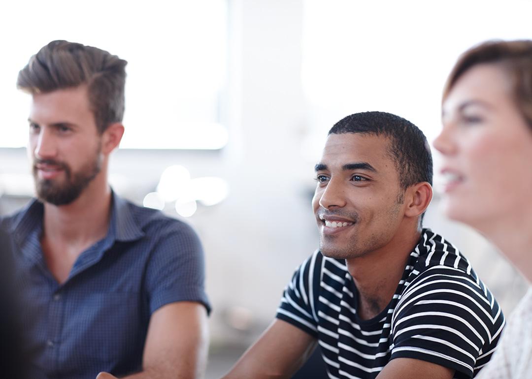 Office employees listening during a workshop session about team development in the workplace.