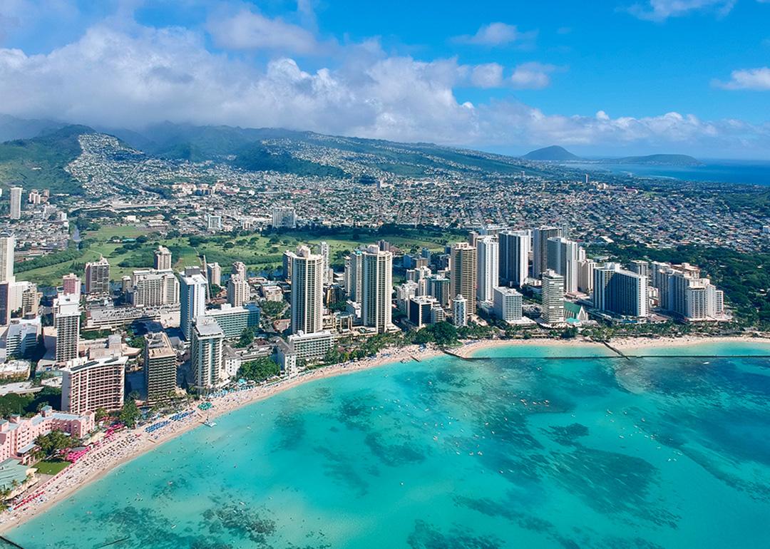 An aerial photo of Honolulu, Hawaii's coast and skyline.