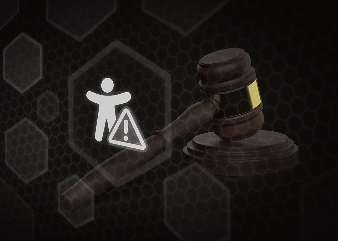 A 3D render illustrating a legal hammer resting next to an accessibility icon featuring a warning triangle sign as a concept of accessibility law.