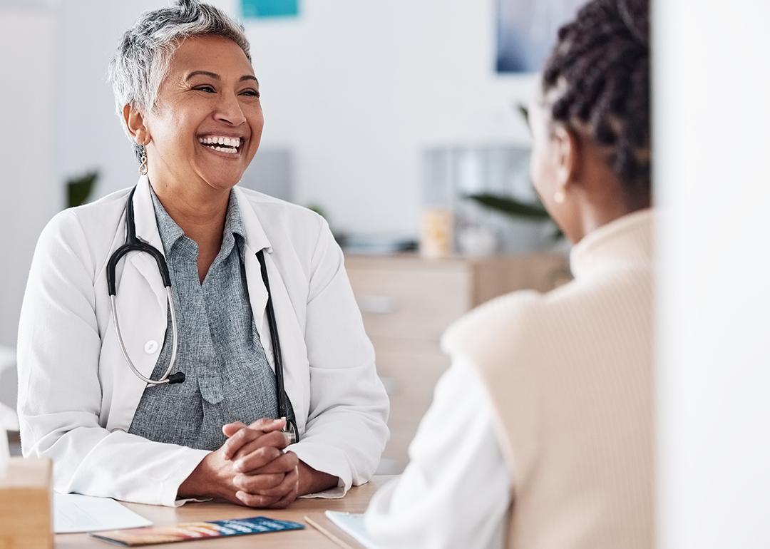 A female doctor happily engaged in a discussion with a patient.