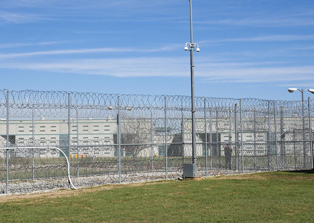 A fence, barbed wire and a guard are visible at the Allan B. Polunsky Unit, the prison that houses the 169 men on Texas' death row in Livingston, Texas.