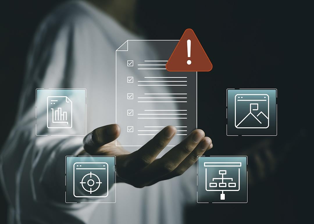 A business person holding a floating and virtual checklist interface with document icons.