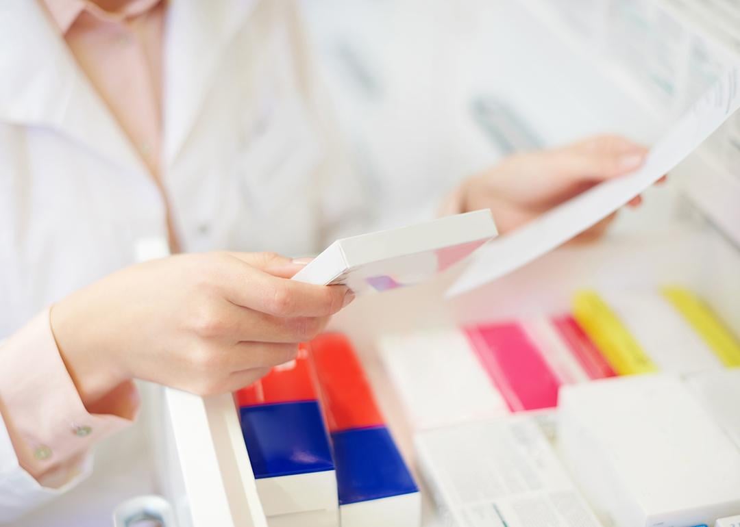 A pharmacist filling prescription at a pharmacy.