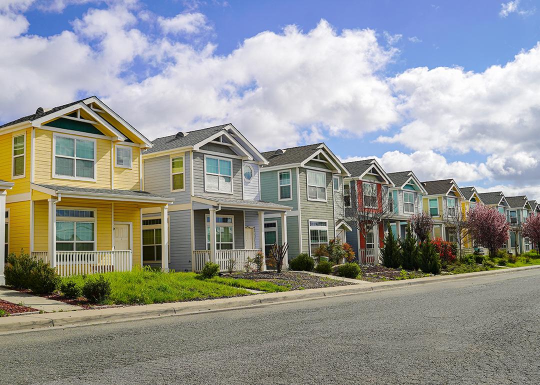 A row of colorful family homes in a residential neighborhood.