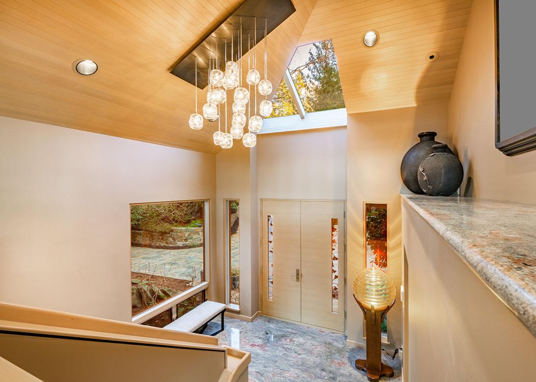 A grand entry foyer of a luxury home with multi-glass ball chandelier.