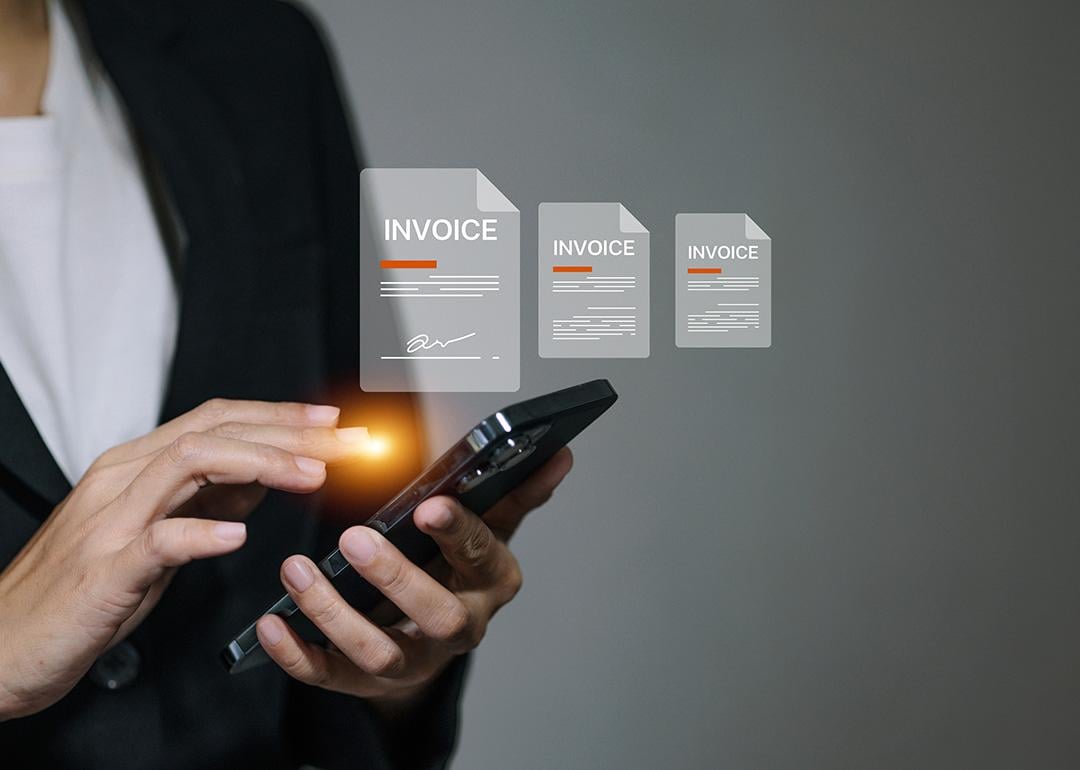 A business manager signing digital invoice documents from her smartphone.