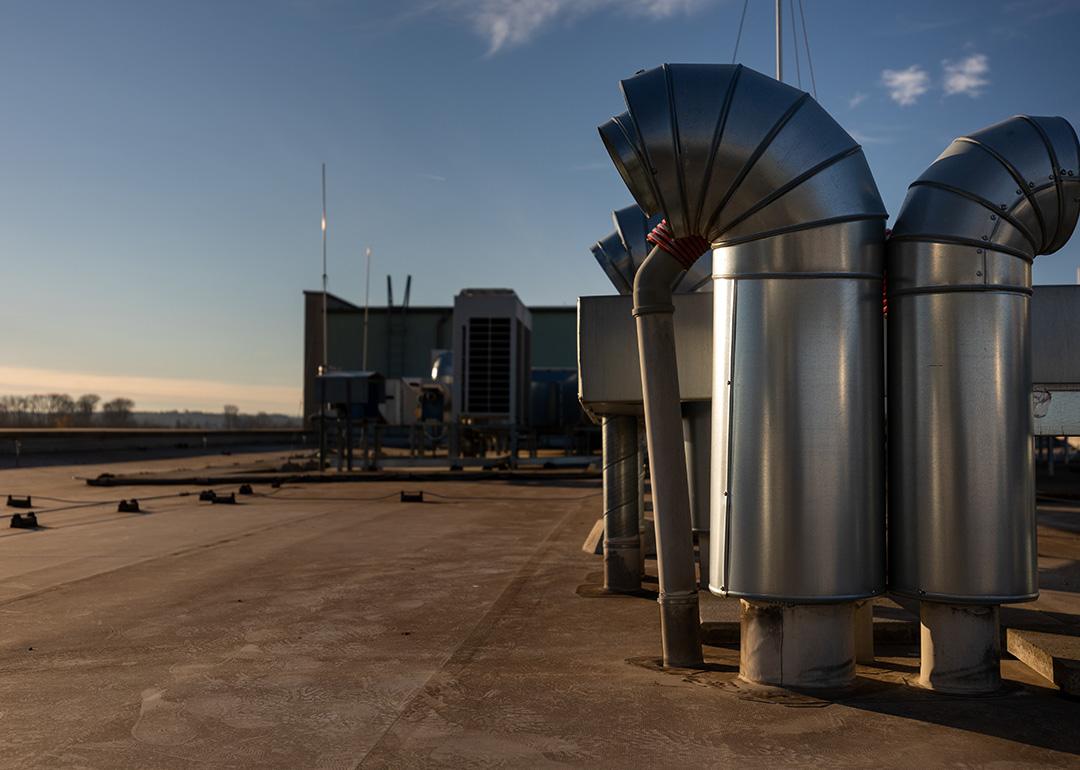 External air conditioning units and ventilation system installed on an industrial building's roof.