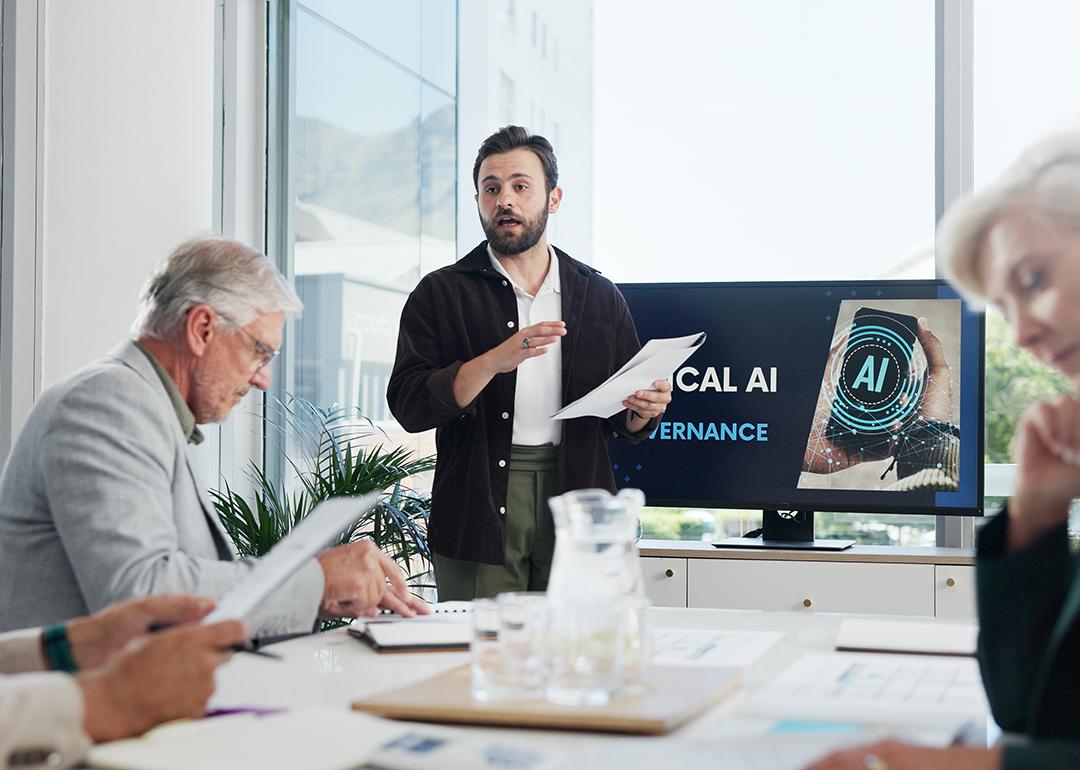 An IT developer presenting AI governance topic during an office meeting.