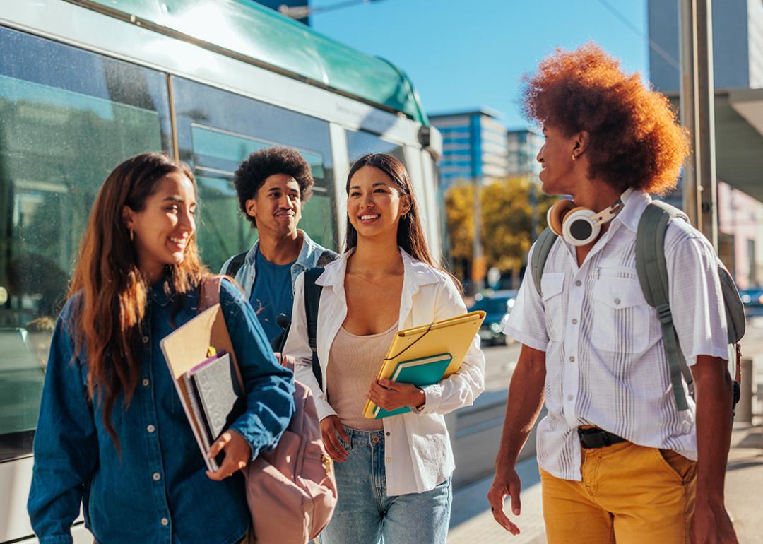 A group of students catching the train to home from school.